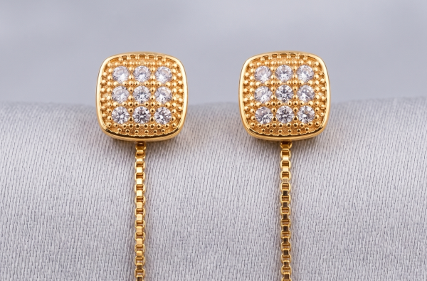 A pair of elegant gold square-and-dangle drop earrings with a polished finish